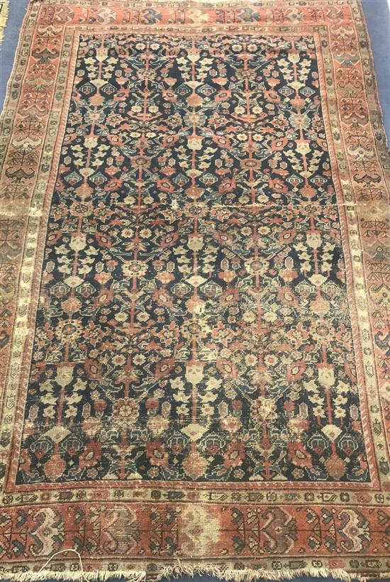 A North West Persian rust ground rug approx. 200 x 130cm.